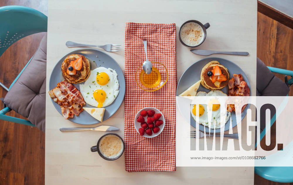Delicious fried eggs with bacon and cheese for breakfast, Model released