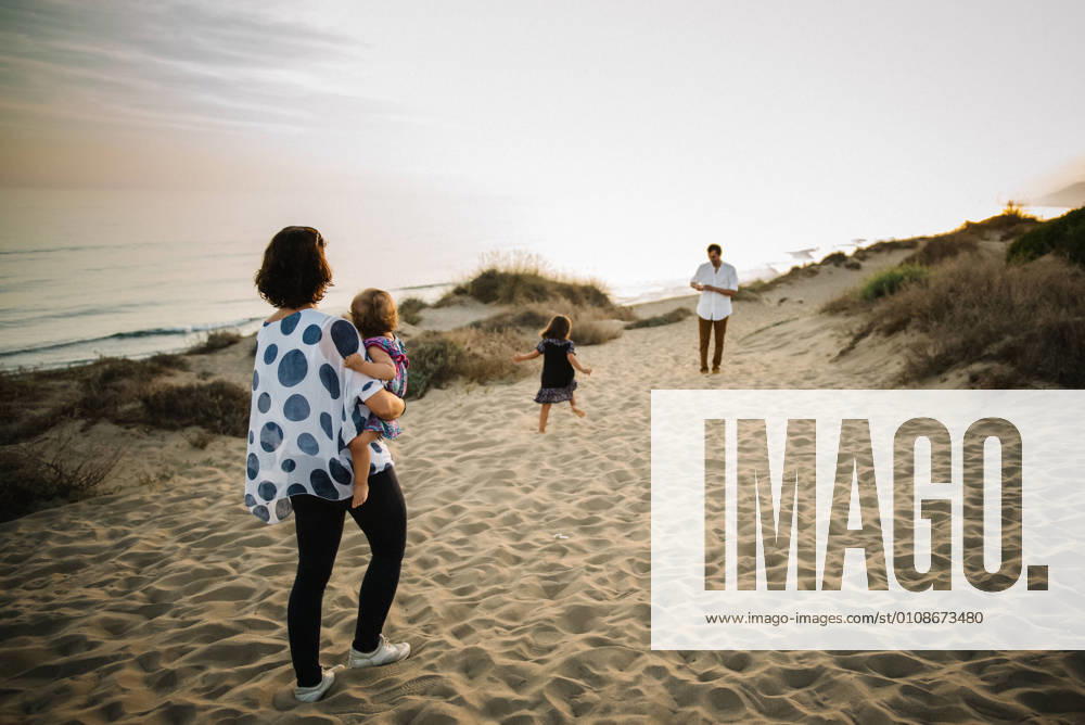 Family walking on beach