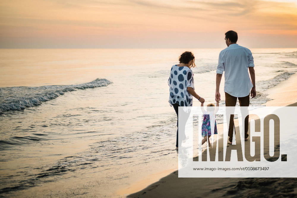 Family walking on beach