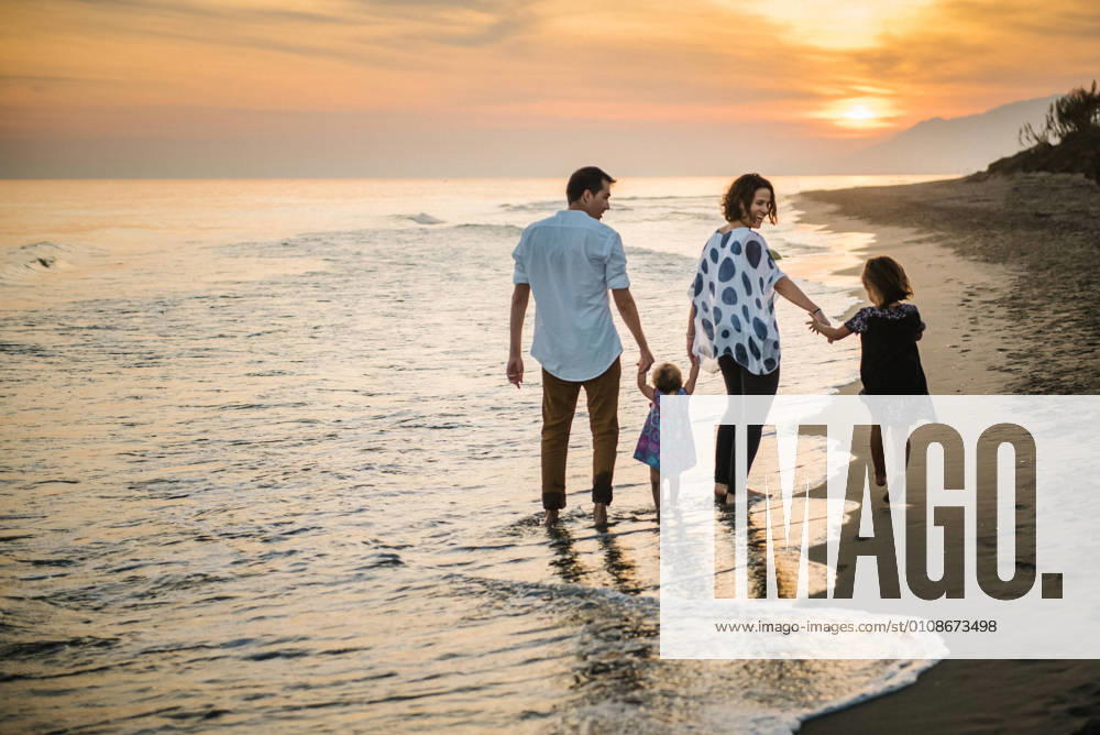 Family walking on beach