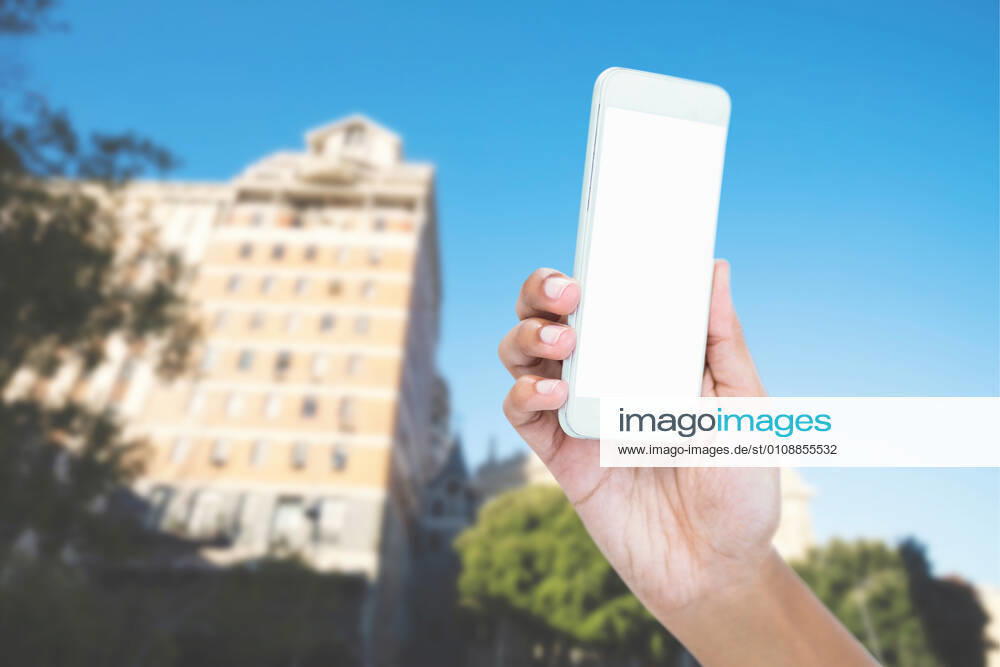 Composite image of cropped image of businesswoman holding smart phone Composite image of cropped image of businesswoman holding smart phoneBlue Sky, Summer, Sun, Sunny, Bright, Cityscape, Urban, City, Skyscraper, Building, Businesswoman, Business, Phone, Holding, Communication, Connection, Wireless, Mobile Phone, Cellphone, Smartphone, Wireless Technology, Showing, Screen, Copy Space, Hand, Close-up