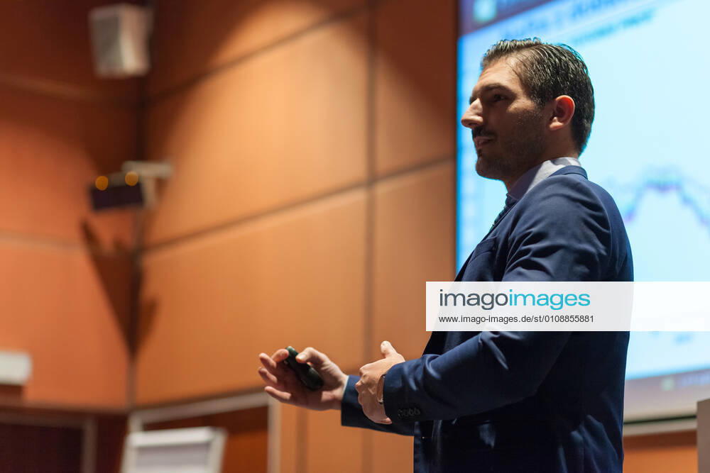 Speaker giving talk at Business Conference. Speaker giving talk on podium at Business Conference. Entrepreneurship club. Horisontal composition., model releasedbusiness, businessman, speaker, speech, lecture, event, presentation, conference, congress, meeting, manager, entrepreneur, corporate, male, expert, education, seminar, academic, academy, coaching, convention, discussion, educator, entrepreneurship, explaining, faculty, information, institute, knowledge, podium, professional, screen, study, summit, symposium, teacher, teaching, training, university, director, consultant, talk, chart, suit, lecture hall, executive, gesturing, briefing, workshop, man,