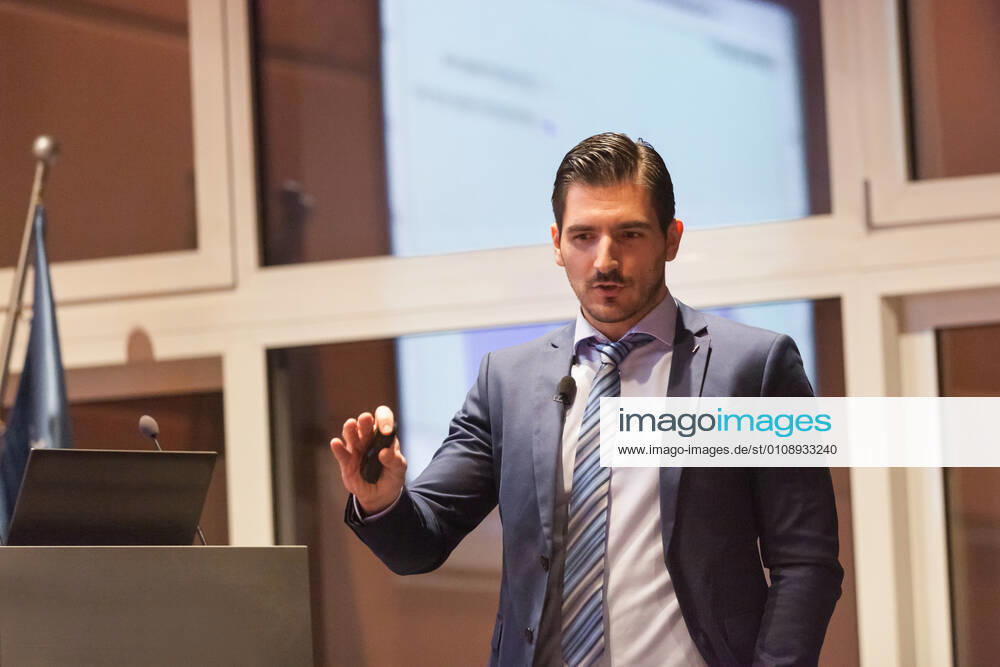 Speaker giving talk at Business Conference. Speaker giving talk on podium at Business Conference. Entrepreneurship club. Horizontal composition., model releasedbusiness, businessman, speaker, speech, lecture, event, presentation, conference, congress, meeting, manager, entrepreneur, corporate, male, expert, education, seminar, academic, academy, coaching, convention, discussion, educator, entrepreneurship, explaining, faculty, information, institute, knowledge, podium, professional, screen, study, summit, symposium, teacher, teaching, training, university, director, consultant, talk, chart, suit, lecture hall, executive, gesturing, briefing, workshop, man,