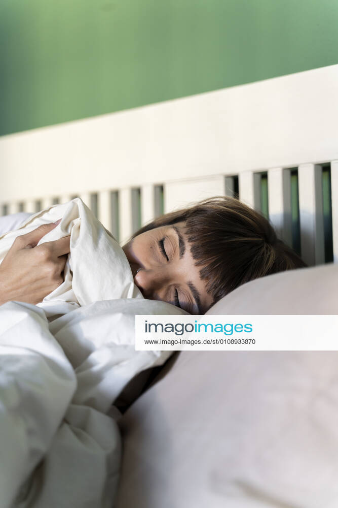 Woman sleeping on bed at home model released Symbolfoto property released AFVF07708