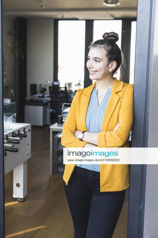 Female entrepreneur standing with arms crossed on entrance of office model released Symbolfoto property released UUF22107