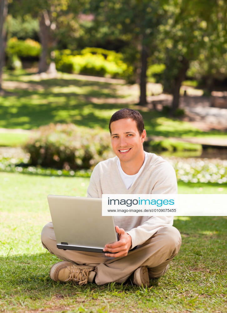 Man working on his laptop in the park Man working on his laptop in the park during the summer, model releasedadult, attractive, carefree, garden, green, greenery, handsome, happiness, happy, leisure, lifestyle, male, men, middle, one, outdoor, outside, park, people, person, relax, relaxation, single, sit, smile, summer, young, man, smiling, portrait, park, tree, laptop, working,