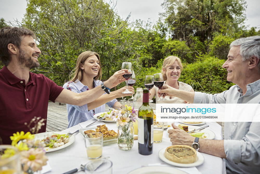 Happy family toasting wine glasses