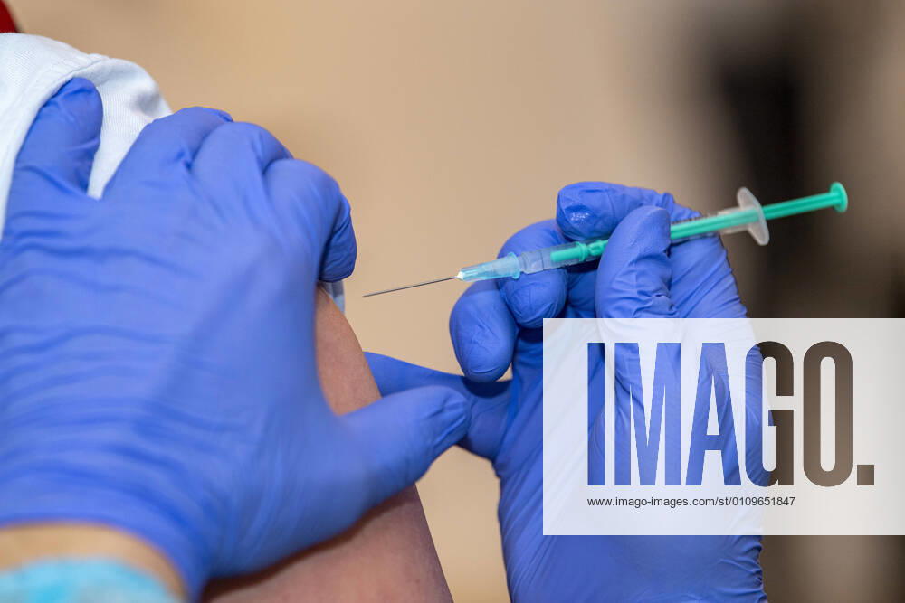 Corona-Schutzimpfung in einem Seniorenheim Ein Arzt setzt die Nadel am Oberarm eines Bewohners eines Altenheims an, der gegen eine Infektion mit dem Coronavirus geimpft wird. In einem Seniorenheim werden die Bewohner gegen eine Infektion mit dem Coronavirus geimpft. Für den Aufbau des Impfschutzes sind mit dem mRNA-Impfstoff von BioNTech zwei Impfungen im Abstand von 21 Tagen notwendig. Rietberg Nordrhein-Westfalen Deutschland