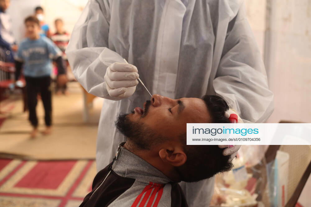 (210111) -- RAFAH, Jan. 11, 2021 -- A medical worker collects a swab sample from a man to test for the COVID-19 in the southern Gaza Strip city of Rafah, Jan. 11, 2021. (Photo by Xinhua) MIDEAST-GAZA-RAFAH-COVID-19-TEST KhaledxOmar