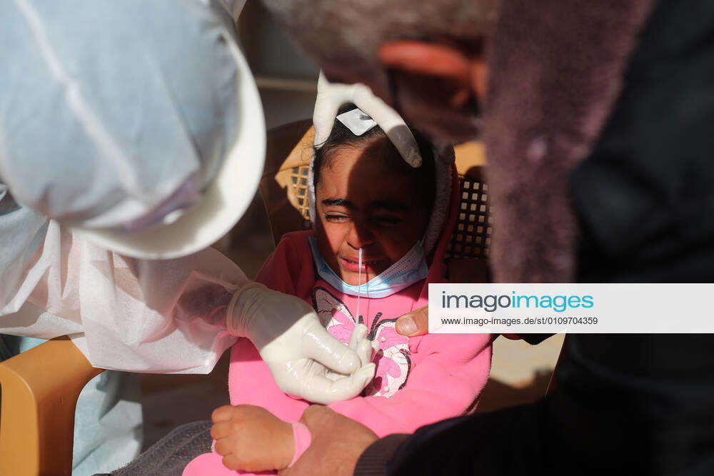 (210111) -- RAFAH, Jan. 11, 2021 -- A medical worker collects a swab sample from a girl to test for the COVID-19 in the southern Gaza Strip city of Rafah, Jan. 11, 2021. (Photo by Xinhua) MIDEAST-GAZA-RAFAH-COVID-19-TEST KhaledxOmar