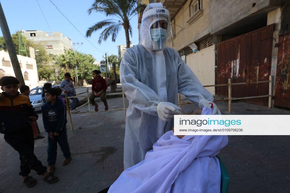 Deir Al-Balah, Gaza Strip, Palestinian Territory: A Palestinian medical worker wearing protective gear, takes a random swab sample for COVID-19 testing, in Deir al-Balah, central of Gaza Strip, on January 11, 2021. The Palestinian Authority (PA) has said it expects to receive its first COVID-19 vaccine doses in March under a deal with British drug giant AstraZeneca, and accused Israel of ignoring its responsibilities to ensure vaccines are available in occupied territory Deir Al-Balah Palestinian Territory - ZUMAap3_ 20210111_zaf_ap3_032