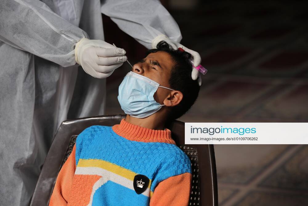 Deir Al-Balah, Gaza Strip, Palestinian Territory: A Palestinian medical worker wearing protective gear, takes a random swab sample for COVID-19 testing, in Deir al-Balah, central of Gaza Strip, on January 11, 2021. The Palestinian Authority (PA) has said it expects to receive its first COVID-19 vaccine doses in March under a deal with British drug giant AstraZeneca, and accused Israel of ignoring its responsibilities to ensure vaccines are available in occupied territory Deir Al-Balah Palestinian Territory - ZUMAap3_ 20210111_zaf_ap3_034