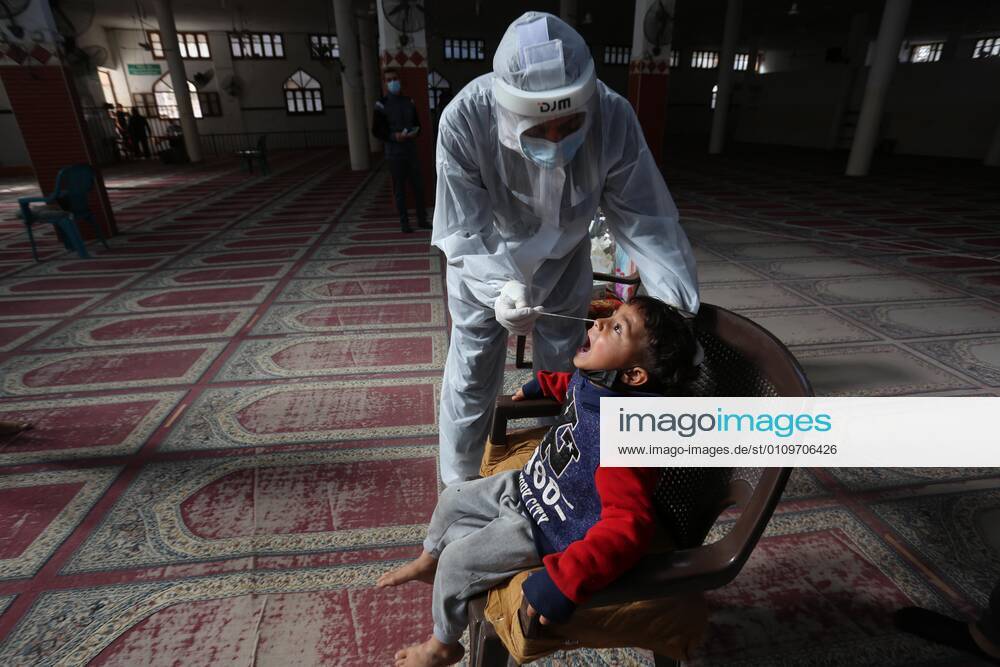 Deir Al-Balah, Gaza Strip, Palestinian Territory: A Palestinian medical worker wearing protective gear, takes a random swab sample for COVID-19 testing inside a mosque, in Deir al-Balah, central of Gaza Strip, on January 11, 2021. The Palestinian Authority (PA) has said it expects to receive its first COVID-19 vaccine doses in March under a deal with British drug giant AstraZeneca, and accused Israel of ignoring its responsibilities to ensure vaccines are available in occupied territory Deir Al-Balah Palestinian Territory - ZUMAap3_ 20210111_zaf_ap3_068