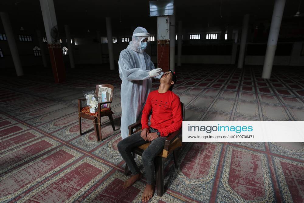 Deir Al-Balah, Gaza Strip, Palestinian Territory: A Palestinian medical worker wearing protective gear, takes a random swab sample for COVID-19 testing inside a mosque, in Deir al-Balah, central of Gaza Strip, on January 11, 2021. The Palestinian Authority (PA) has said it expects to receive its first COVID-19 vaccine doses in March under a deal with British drug giant AstraZeneca, and accused Israel of ignoring its responsibilities to ensure vaccines are available in occupied territory Deir Al-Balah Palestinian Territory - ZUMAap3_ 20210111_zaf_ap3_070