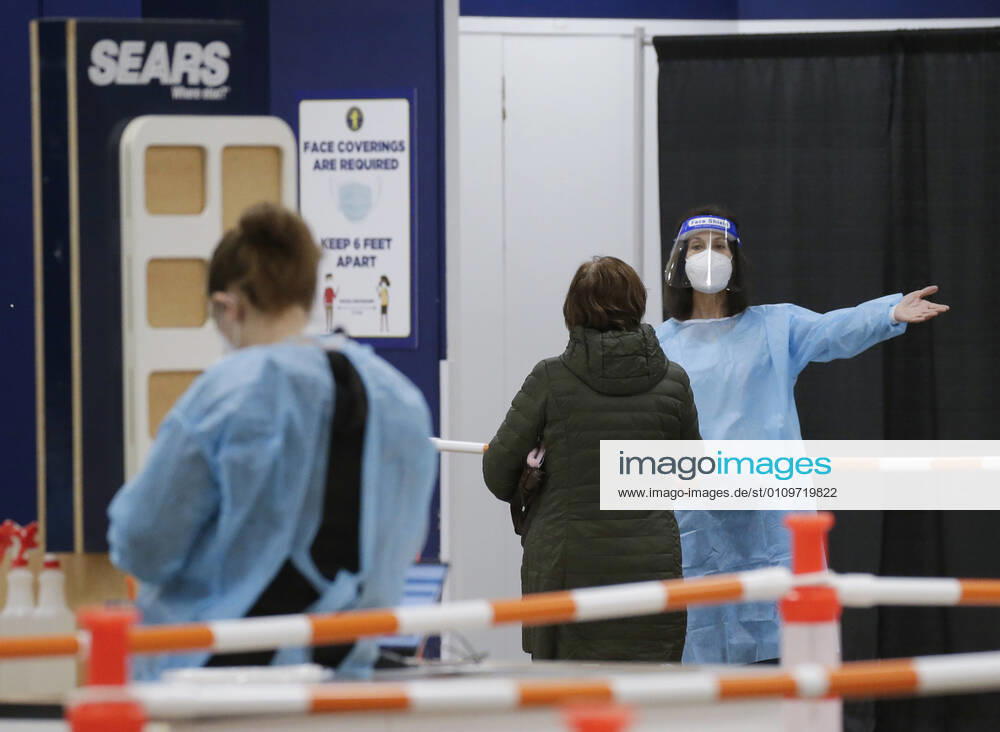 People arrive and get checked in to receive a coronavirus vaccine at an Essex County COVID-19 Vaccination Site located at a closed Sears retail store in the Livingston Mall in Livingston, New Jersey on Monday, January 11, 2021. Public health agencies and health-care groups are using the retailer s empty stores to deliver Vaccines in several locations around parts of the United States. NYP20210111113 JohnxAngelillo