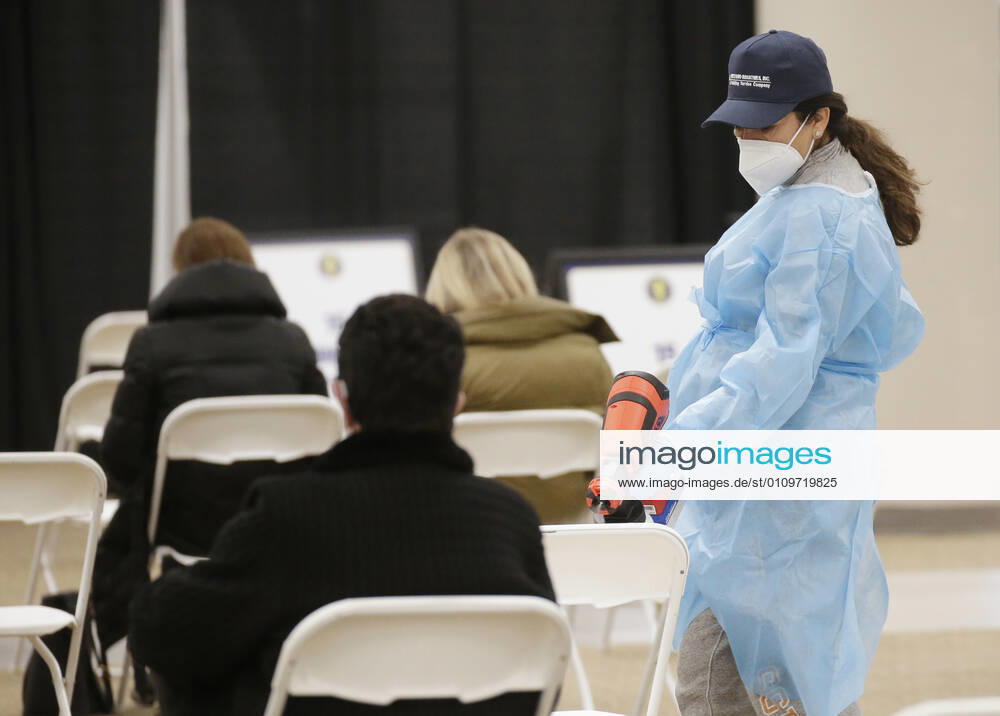 Workers sanitize areas where people sit and wait to receive a coronavirus vaccine at an Essex County COVID-19 Vaccination Site located at a closed Sears retail store in the Livingston Mall in Livingston, New Jersey on Monday, January 11, 2021. Public health agencies and health-care groups are using the retailer s empty stores to deliver Vaccines in several locations around parts of the United States. NYP20210111116 JohnxAngelillo
