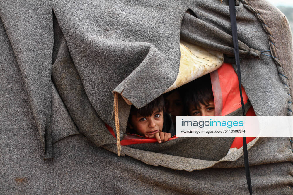 The photos show the drowning of the camps and the suffering of the displaced Syrians in the village of Kafr Arrouq in the northern countryside of Idlib, after the severe rainstorms that the region witnessed, and the displaced suffer every year from the flooding of the camps during rainstorms and deaths due to severe cold inside the tents - ZUMAa323 20210120_zip_a323_008