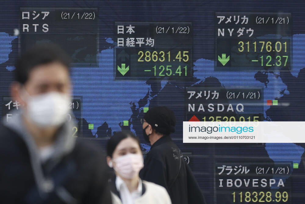 People wearing face masks to prevent the spread of the coronavirus walk past an electronic stock board showing Japan s Nikkei Stock Average, which ended down -125.41 points or -0.44 percent to close at 28,631.45 in downtown Tokyo. Tokyo Japan - ZUMAm191 20210122_zap_m191_002