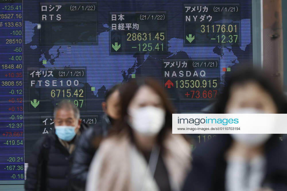 People wearing face masks to prevent the spread of the coronavirus walk past an electronic stock board showing Japan s Nikkei Stock Average, which ended down -125.41 points or -0.44 percent to close at 28,631.45 in downtown Tokyo. Tokyo Japan - ZUMAm191 20210122_zap_m191_003