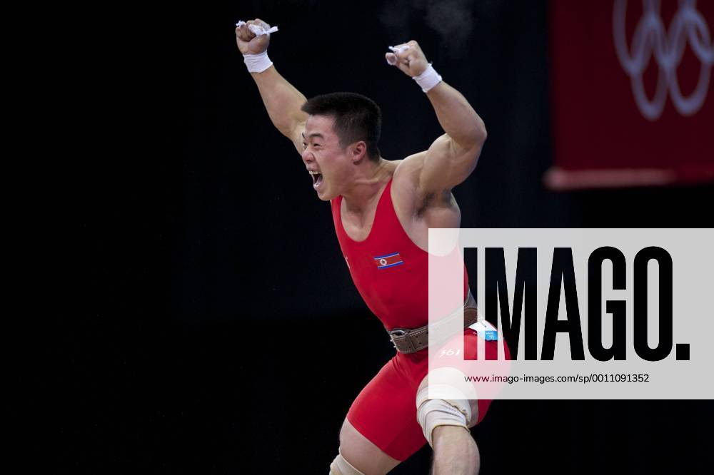 London, England, United Kingdom - KIM UN GUK (PRK) celebrates completing a lift in the men s 62kg weightlifting competition at ExCeL in London. Guk won an Olympic goldmedal and set an Olympic record in the the snatch competition with a lift of 153kg. Olympics 2012 - Weightlifting - ZUMAw10