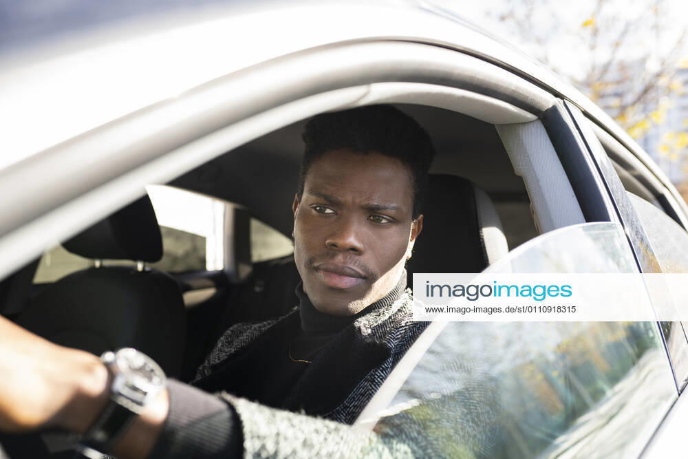 Young man driving car model released Symbolfoto JCCMF00790