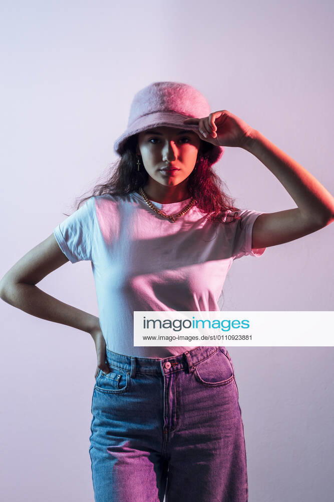 Teenage girl wearing hat posing against white background model released Symbolfoto JRVF00069