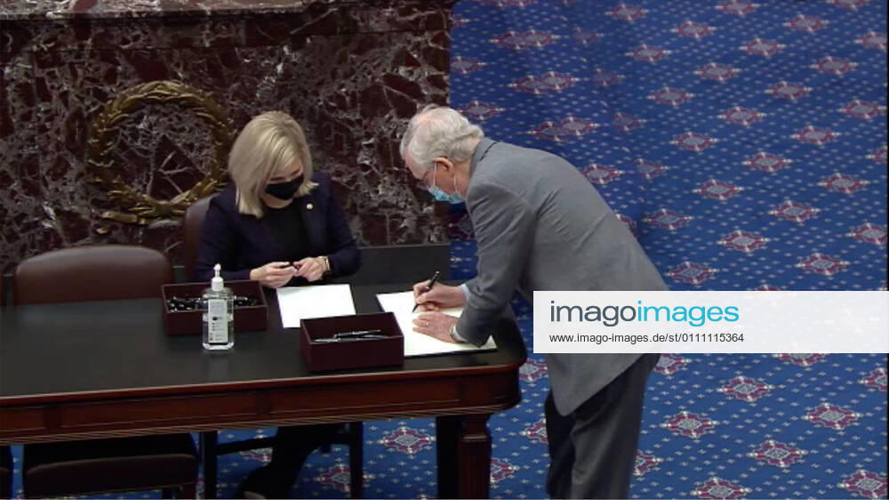 In this image from United States Senate television, US Senate Minority Leader Mitch McConnell (Republican of Kentucky) signs the oath book to serve as an impeachment juror during the second impeachment trial of former US President Donald J. Trump in the US Senate in the US Capitol in Washington, DC on Tuesday, January 26, 2021..Mandatory Credit: US Senate TV via CNP Washington USA - ZUMAs152 20210126_zaa_s152_155