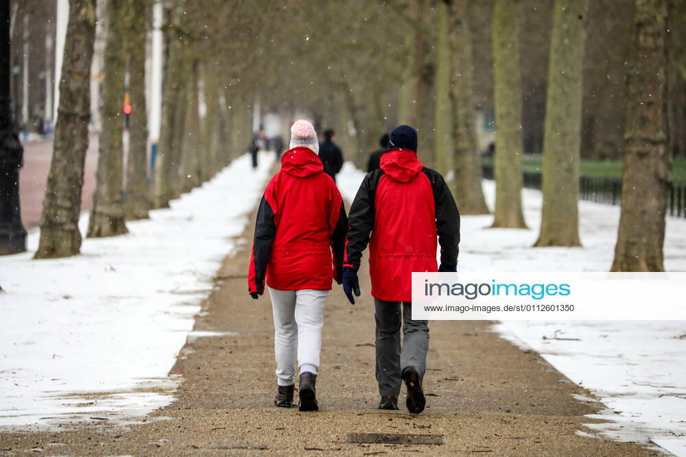 People walk along a snow covered St James Park..London has been experiencing snow as the Storm Darcy hits the city. London United Kingdom - ZUMAs197 20210209_zaa_s197_247