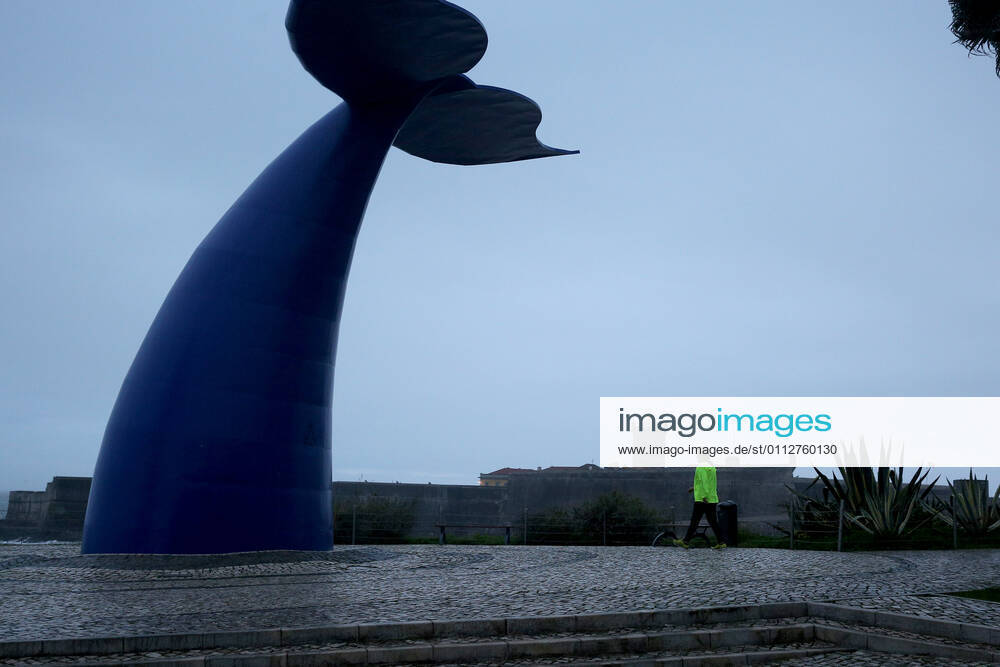 A man wearing a face mask walks by a giant whale tail in Oeiras, near Lisbon, Portugal on February 11, 2021. Portugal extended on Thursday a nationwide lockdown until at least March 1 to tackle its worst surge of COVID-19 infections since the pandemic began, but Prime Minister Antonio Costa warned the strict rules were likely to stay in place for longer. Lisbon Portugal - ZUMAf123 20210211_zap_f123_004