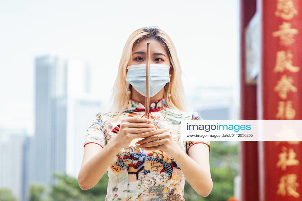 A woman offers prayers while holding a joss stick at the Thean Hou Temple during the Lunar New Year. Kuala Lumpur Malaysia - ZUMAs197 20210212_zaa_s197_101