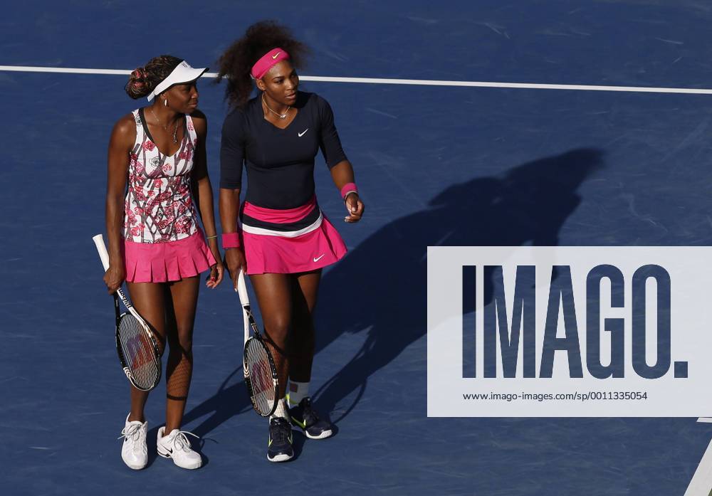Venus and Serena Williams talk in between points in their doubles match in Arthur Ashe Stadium at the BillieJean King National Tennis Center in New York City on August 31, 2012. NYP20120831146