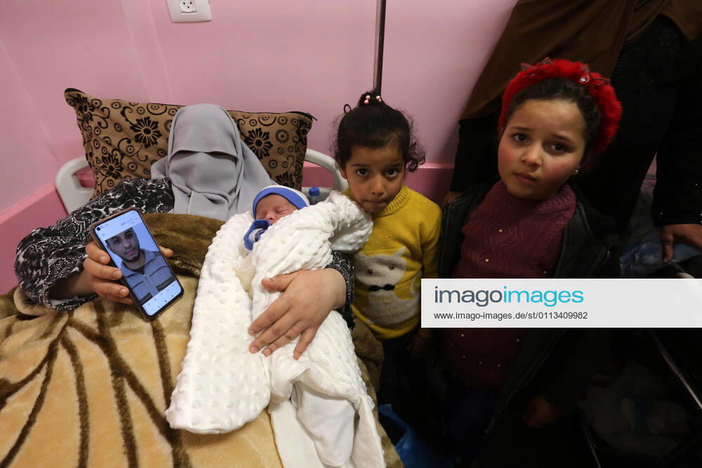 khan Younis, Gaza Strip, Palestinian Territory: The wife of the Palestinian prisoner Mohammad al-Qudra, holds her newborn baby, from whom she conceived with sperm smuggled out of an Israeli prison, at Nasser Medical Complex in khan Younis in the southern of Gaza strip on February 18, 2021. Since 2004, Palestinian security prisoners, who are denied conjugal visitations by their wives, have tried to smuggle their sperm out of Israeli prisons, so that their wives can be inseminated in fertility clinics in the West Bank and Ghazza, and bear them children khan Younis Palestinian Territory - ZUMAap3_ 20210218_zaf_ap3_175