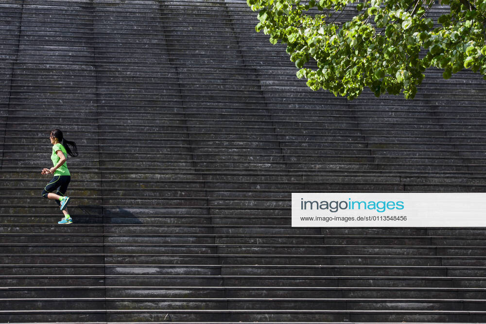 Woman running up wooden stairs in Paris France, Île-de-France, Paris CR_THHE210219-656434-01 ,model released, Symbolfoto