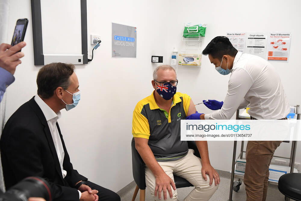 SCOTT MORRISON COVID19 VACCINATION, Australian Health Minister Greg Hunt looks on as Prime Minister Scott Morrison receives his COVID-19 vaccination during a visit to Castle Hill Medical Centre to preview the COVID-19 vaccination program on Sunday, February 21, 2021. The PM has received a COVID-19 vaccination, joining a small group of people who are the first in Australia to receive a jab. ( NO ARCHIVING, , NO USE IN BOOKS WITHOUT CONSENT SYDNEY NSW AUSTRALIA