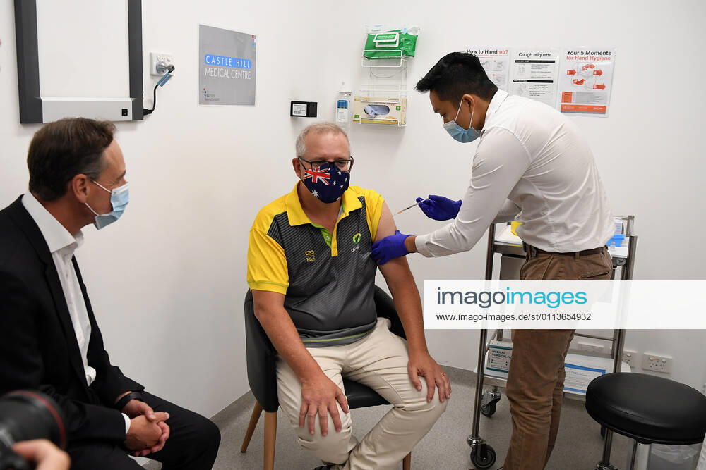 SCOTT MORRISON COVID19 VACCINATION, Australian Health Minister Greg Hunt looks on as Prime Minister Scott Morrison receives his COVID-19 vaccination during a visit to Castle Hill Medical Centre to preview the COVID-19 vaccination program on Sunday, February 21, 2021. The PM has received a COVID-19 vaccination, joining a small group of people who are the first in Australia to receive a jab. ( NO ARCHIVING, , NO USE IN BOOKS WITHOUT CONSENT SYDNEY NSW AUSTRALIA