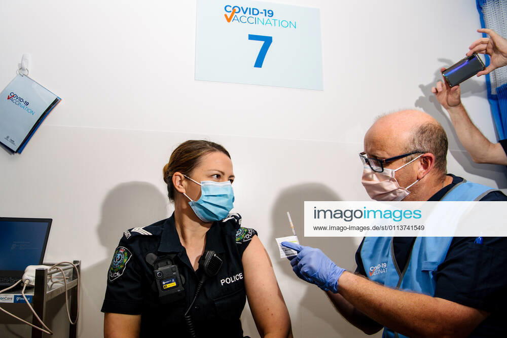 SA COVID19 VACCINE ROLLOUT, Front-line worker SAPOL Senior Sergeant Amanda Kuchel receives the Pfizer Vaccine from a COVID-19 Vaccinator Health Care Worker at the Royal Adelaide Hospital in Adelaide, Monday, February 22, 2021. Australia will begin its roll out of the Pfizer coronavirus vaccine on Monday, the country s most complicated logistical exercise to date.( NO ARCHIVING, , NO USE IN BOOKS WITHOUT CONSENT ADELAIDE SA AUSTRALIA