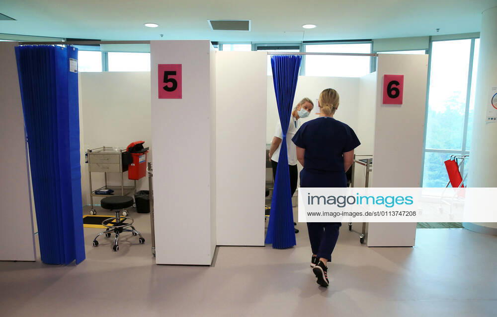 VIC COVID19 VACCINE ROLLOUT, Covid screening nurse Grace Gibney heads into a cubicle to receive one of the first Pfizer coronavirus vaccines at Austin Health in Melbourne, Monday, February 22, 2021. Australia will begin its roll out of the Pfizer coronavirus vaccine on Monday, the country s most complicated logistical exercise to date. ( NO ARCHIVING, , NO USE IN BOOKS WITHOUT CONSENT MELBOURNE VIC AUSTRALIA