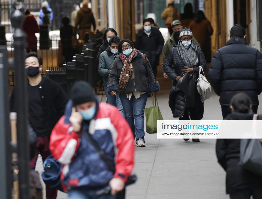 Pedestrian walk wearing face masks to protect from and to prevent the spread of the coronavirus on Wall Street in New York City on Monday February 22, 2021. COVID-19 deaths have now surpassed the 500,000 mark in the United States. NYP20210222110 JohnxAngelillo