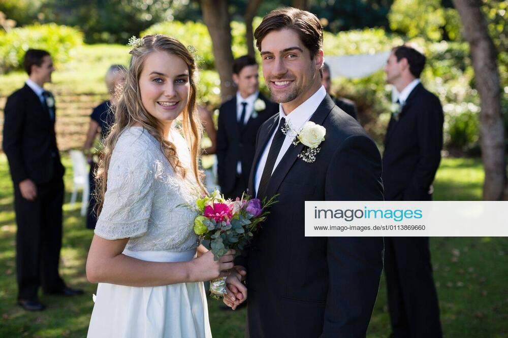 Happy bride and groom standing in park Portrait of happy bride and groom standing in park, model released, , property released, Cape Town, South Africa, 2017-05-01T23:00:00.000Z, 1050866.jpg, sunny, summertime, park, courtyard, wedding, marriage, life event, ceremony, celebration, event, elegance, fashion, fashionable, modern, bride, groom, wedding dress, full suit, standing, smiling, happy, cheerful, bouquet, flower, holding, reception, together, stylish, attractive, beginnings, lifestyle, handsome, smart, beautiful, love, affection, closeness, fondness, bonding, luxury, newly married, just married, confidence, couple, relationship 50s, Mature Adult, Woman, Female, Caucasian, 30s, Mid Adult, Man, Male, 20s, Young Adult, 50-54 Years, Matur