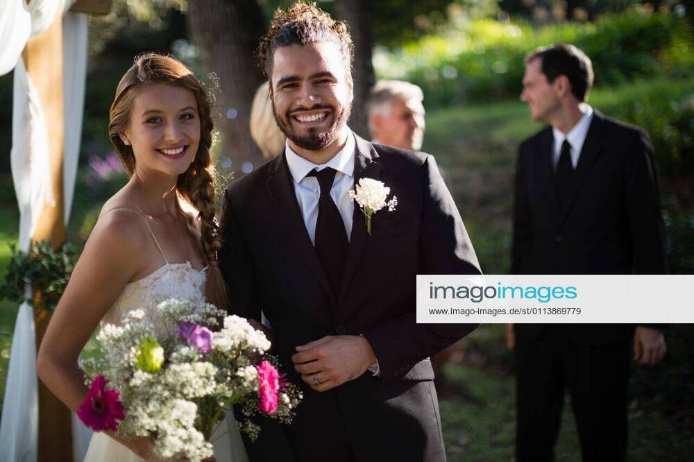 Happy bride and groom standing in park Portrait of happy bride and groom standing in park, model released, , property released, Cape Town, South Africa, 2017-05-01T23:00:00.000Z, 1050946.jpg, sunny, summertime, park, courtyard, wedding, marriage, life event, ceremony, celebration, event, elegance, fashion, fashionable, modern, bride, groom, wedding dress, full suit, standing, smiling, happy, cheerful, bouquet, flower, holding, reception, together, stylish, attractive, beginnings, lifestyle, handsome, smart, beautiful, love, affection, closeness, fondness, bonding, luxury, newly married, just married, confidence, couple, relationship 20s, Young Adult, Man, Male, Mixed-Race, Woman, Female, Caucasian, 30s, Mid Adult, 50s, Mature Adult, 20-24