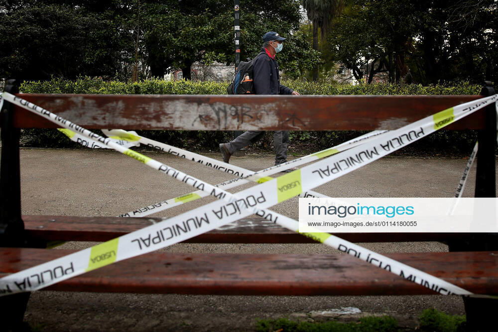 A men wearing a face mask walks by a police taped bench to prevent its use in Lisbon, Portugal on February 25, 2021. Portugal s parliament approved on Thursday the renewal of the state of emergency in the country through March 16, allowing the government to keep all lockdown and anti-COVID-19 measures in place. Lisbon Portugal - ZUMAf123 20210225_zap_f123_004