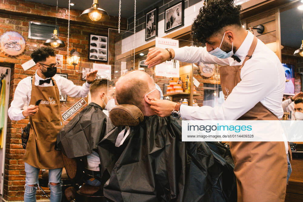 (210301) -- COLOGNE, March 1, 2021 -- Employees serve customers at a hair salon amid COVID-19 pandemic in Cologne, Germany, March 1, 2021. Hair salons in Germany reopened on Monday with COVID-19 prevention measures. (Photo by Xinhua) GERMANY-COLOGNE-COVID-19-HAIR SALON-REOPENING TangxYing