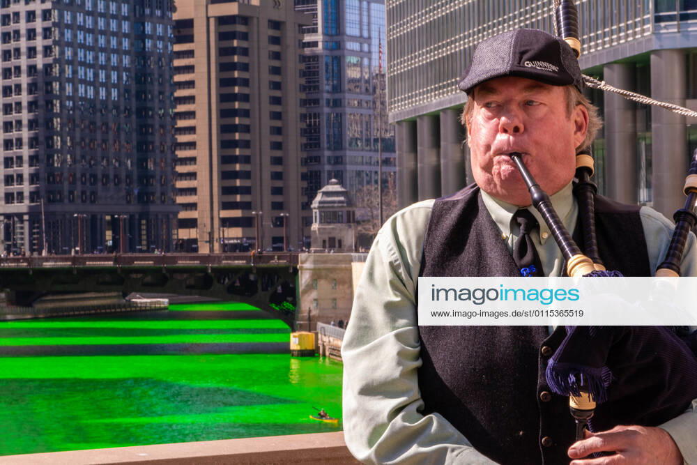 Chicago, IL, U.S: Chris Coomes plays bagpipes ahead of St. Patrick s Day along the Chicago River, dyed green every year to honor the city s Irish American heritage. Chicago U.S. - ZUMAg216 20210313_znp_g216_004