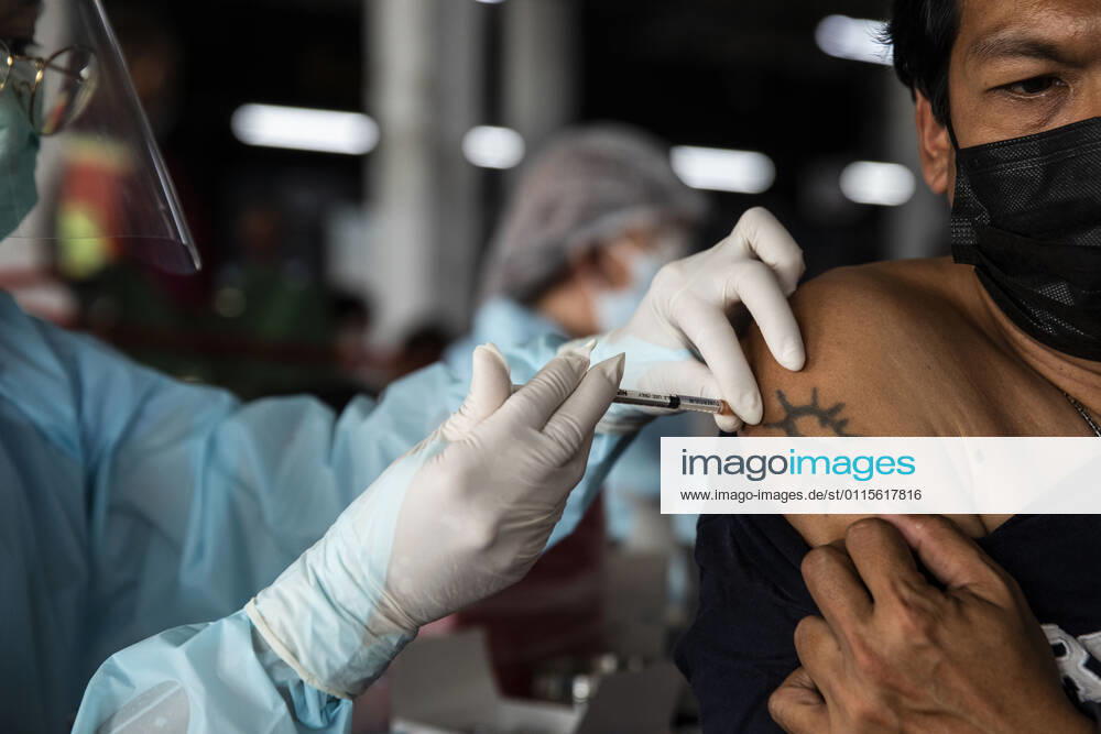 A health worker administers a dose of CoronaVac, a Covid-19 coronavirus vaccine developed by Chinaâ€⠢s Sinovac Biotech ltd, in Bangkok, Thailand, on Friday March 19, 2021. Health workers have been vaccinating 600 residents per day, after a cluster of Covid-19 coronavirus cases were discovered at the Bang Khae market in Bangkok on Wednesday, March 17. Thailand - ZUMAm249 20210319_zip_m249_004