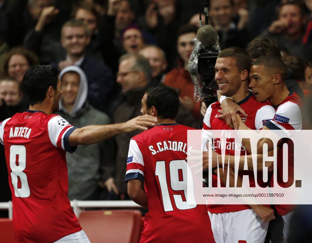 Arsenal s Lukas Podolski celebrates scoring his sides second goal..Football - Champions League Matchday 2 - Emirates Stadium, London - 3 10 12. .