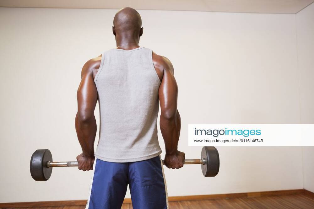 Rear view of a muscular man lifting barbell Rear view of a muscular man lifting barbell in gym, model released, Cape Town, South Africa, 28.02.2014, 357973.jpg, body, fit, fitness, healthy, leisure, lifestyle, sporty, athletic, wellness, body care, strong, athlete, muscular, toned, masculine, gym, health, physical, shape, attractive, bodybuilder, bodybuilding, physique, strength, muscle, bicep, crossfit, arms, club, workout, fitness studio, health club, macho, masculinity, training, wellbeing, working out, biceps, muscles, standing, exercise equipment, barbell, active, equipment, exercise, weights, training, exercise room, lifting, bald, wall 30s, Mid Adult, Man, Male, Black, 35-39 Years, Mid Adult Men, African Ethnicity Indoors,Rear vie