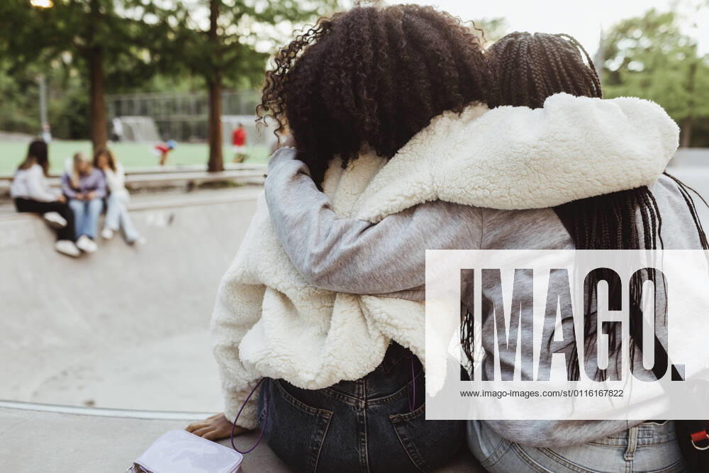 IMAGO Creative: Gesellschaft, Integration Rear view of female friends with arms around at skateboard park Sweden,Stockholm, model released