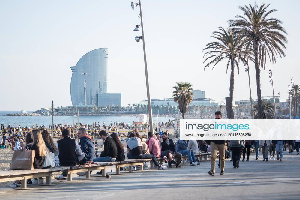 People seen on Barceloneta beach promenade..The Barceloneta Beach in Barcelona is full in the 2021 beach season. In a state of alarm due to the corona virus pandemic, in Catalonia, the use of facemasks and safety distance is mandatory in all public spaces to contain the spread of COVID- 19 pandemic. Barcelona Spain - ZUMAs197 20210403_zab_s197_022