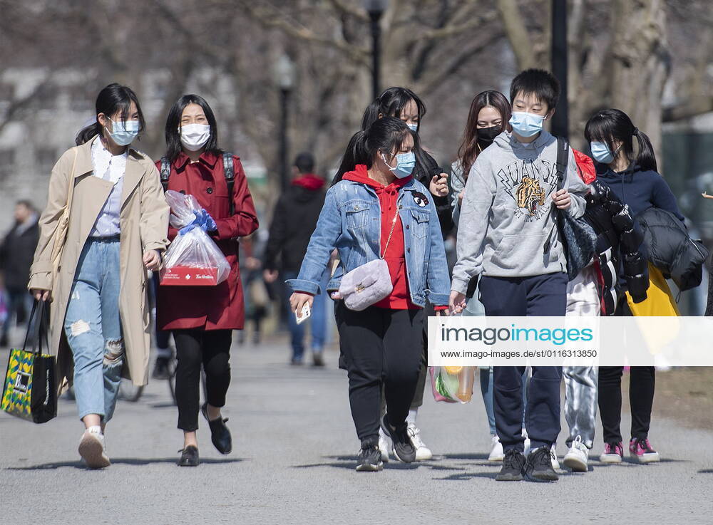 People wear face masks as they walk in a park in Montreal, Sunday, April 4, 2021, as the COVID-19 pandemic continues in Canada and around the world. Montreal Canada - ZUMAc35_ 20210404_zaf_c35_061