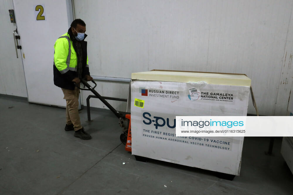 (210404) -- TRIPOLI, April 4, 2021 -- A worker transfers COVID-19 vaccines in Tripoli, Libya, on April 4, 2021. The Libyan Minister of Health Ali Zanati on Sunday announced that a shipment of 101,250 doses of Russia s Sputnik V COVID-19 vaccine, provided by the United Arab Emirates, arrived in Tripoli. (Photo by Xinhua) LIBYA-TRIPOLI-COVID-19 VACCINE-ARRIVAL HamzaxTurkia